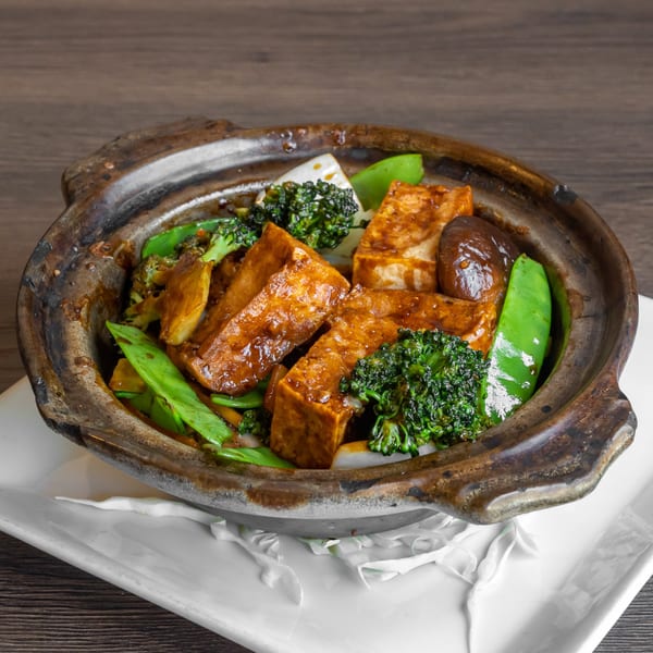 Braised tofu with broccoli, snow peas, and mushrooms in a clay pot, from Go China Restaurant.
